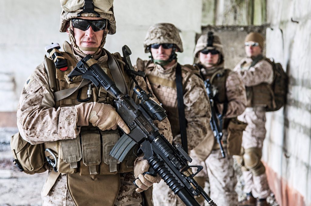 Squad of US marines in ruined building